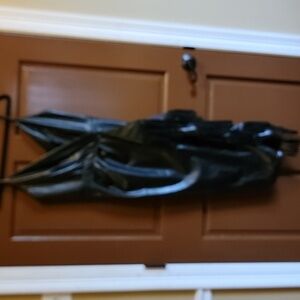 Fate-Faux leather black dress, sleeveless with draped fringe side Size Small.